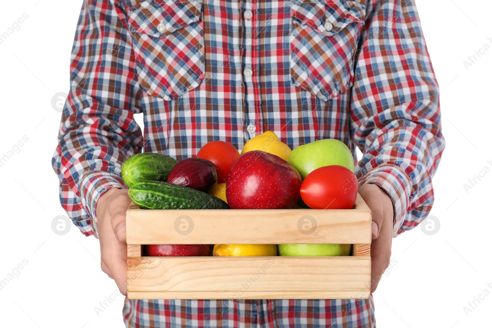 Photo of Man holding wooden crate filled with fresh vegetables and fruits against white background, closeup