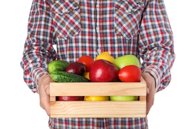 Photo of Man holding wooden crate filled with fresh vegetables and fruits against white background, closeup
