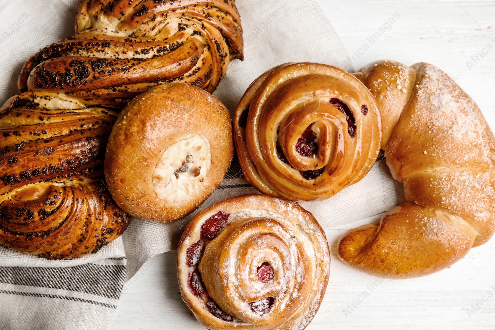 Photo of Different delicious fresh pastries on white wooden background, flat lay