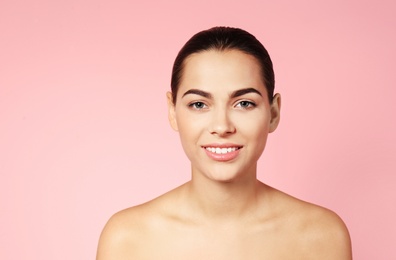 Photo of Portrait of beautiful young woman on color background. Lips contouring, skin care and cosmetic surgery concept