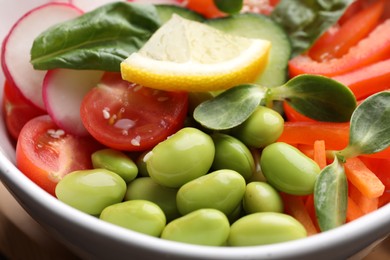 Closeup view of poke bowl with salmon, edamame beans and vegetables