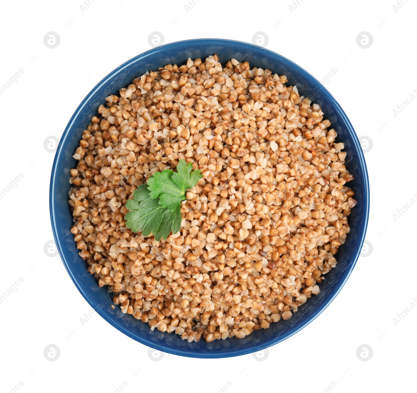 Photo of Bowl of buckwheat porridge with parsley isolated on white, top view