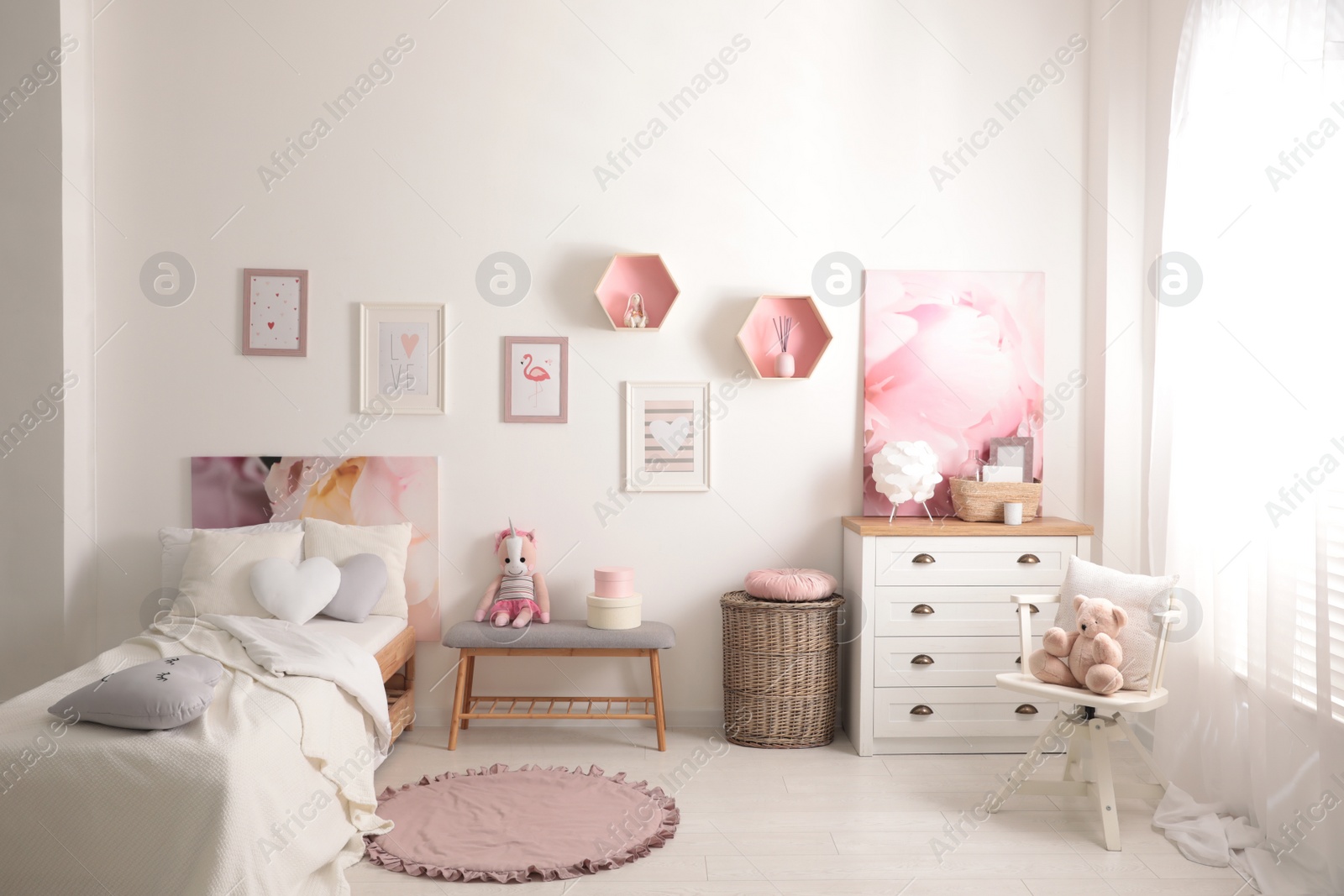 Photo of Modern teenager's room interior with comfortable bed and beautiful pictures