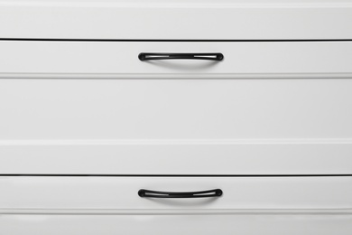 Photo of Modern white chest of drawers as background