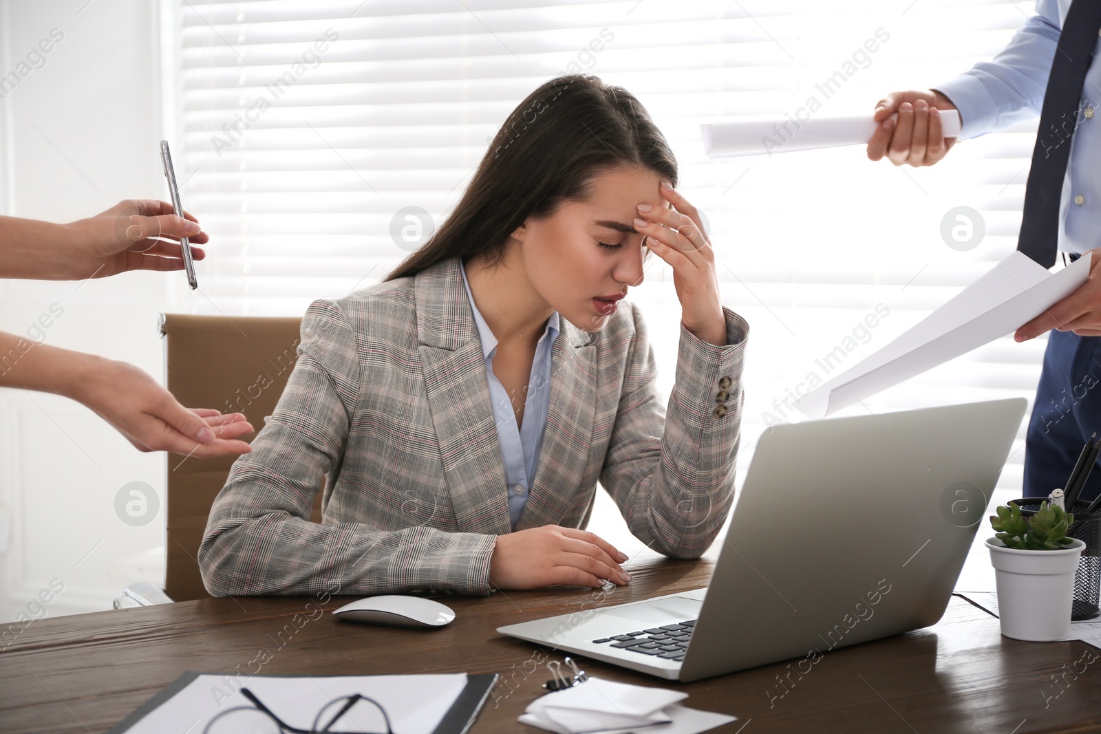 Photo of Businesswoman stressing out at workplace in office