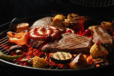 Photo of Assorted delicious meat and vegetables on barbecue grill