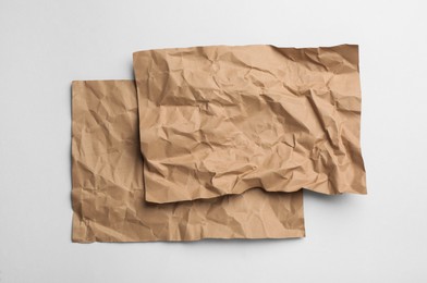 Photo of Sheets of brown paper on white background, top view