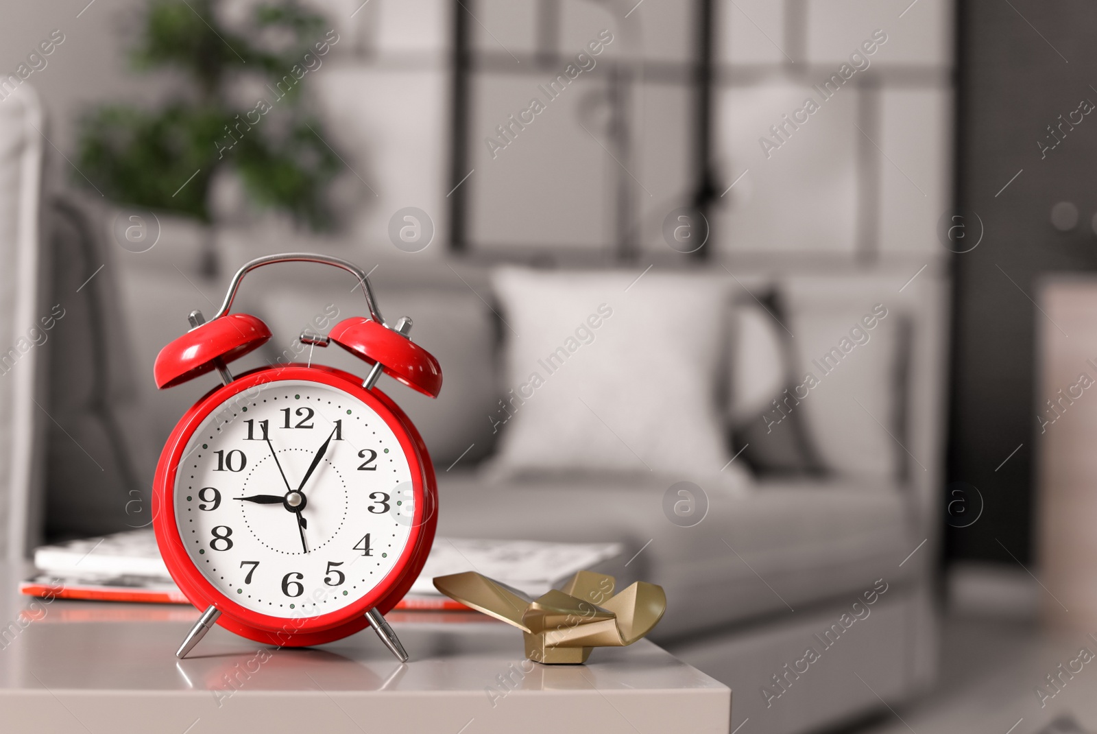 Photo of Alarm clock on table in living room. Time of day