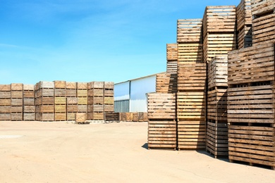 Photo of Old empty wooden crates at warehouse backyard. Space for text