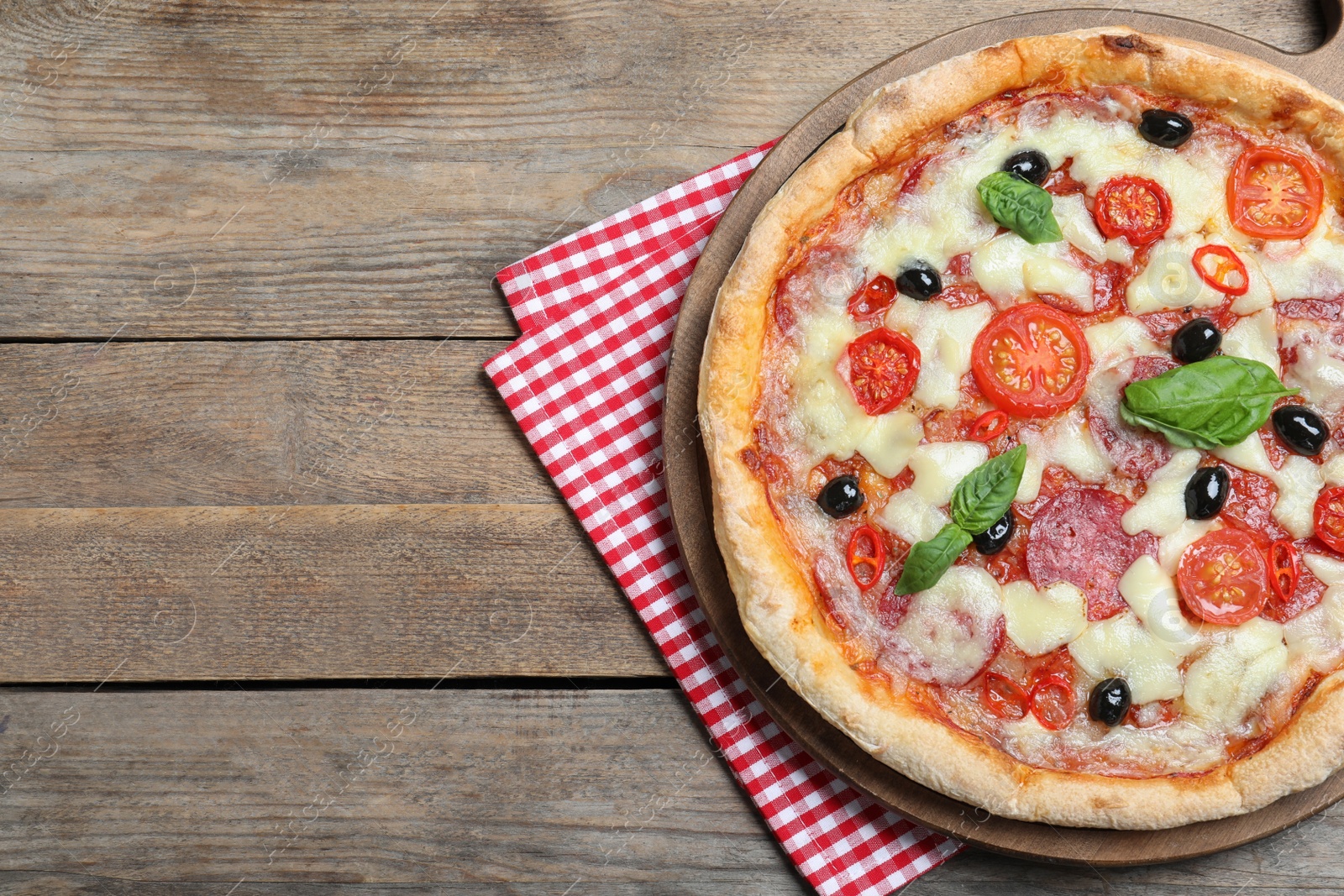 Photo of Delicious pizza Diablo on wooden table, top view. Space for text