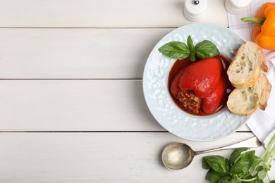 Photo of Delicious stuffed pepper served on white wooden table, flat lay. Space for text