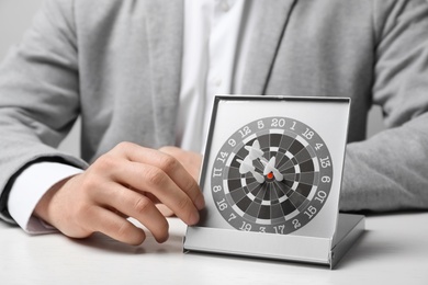 Photo of Man with darts at table. Business trainer concept