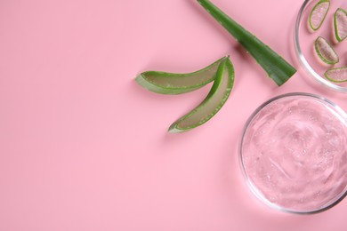 Photo of Flat lay composition with aloe vera leaves and cosmetic gel on pink background. Space for text