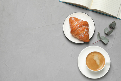 Tasty breakfast served on light grey table, flat lay. Space for text