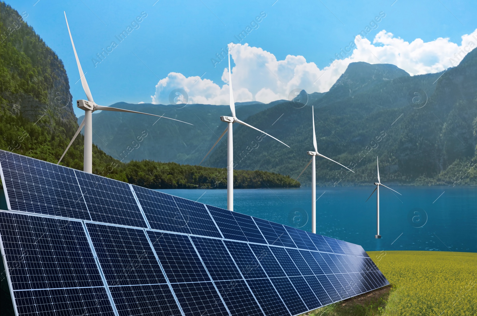 Image of Alternative energy sources. Wind turbines installed in water near bank with solar panels