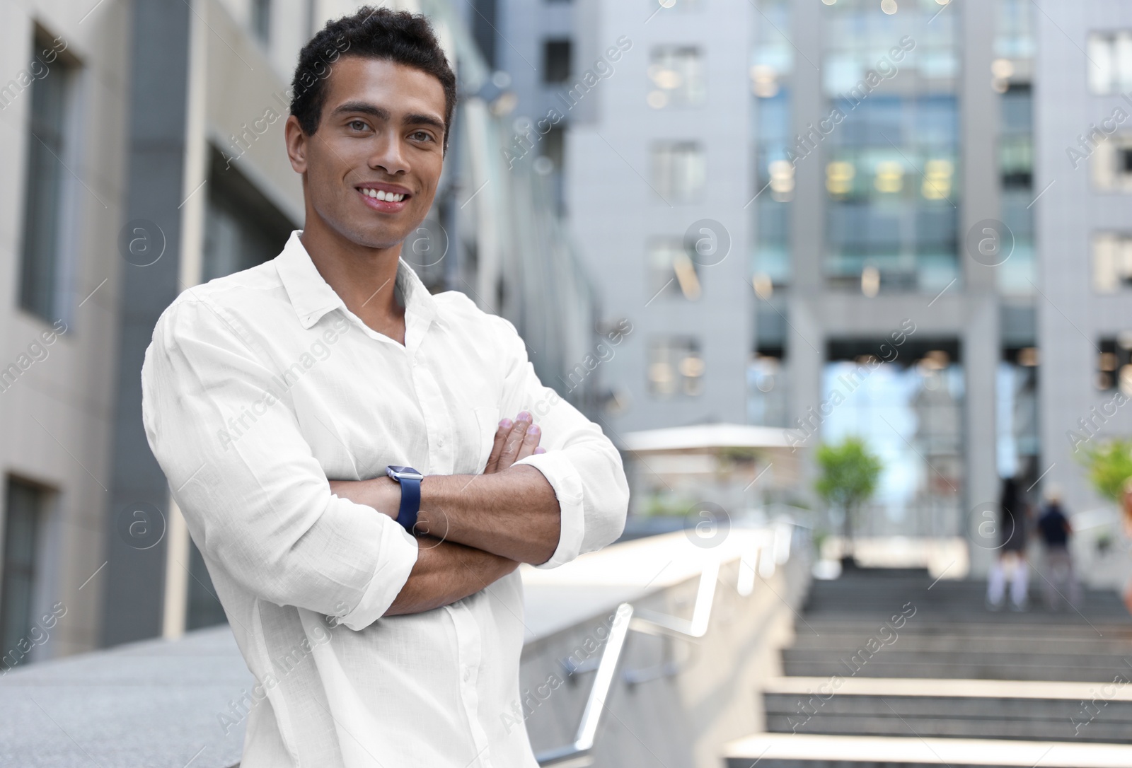 Photo of Handsome young African-American man on city street. Space for text