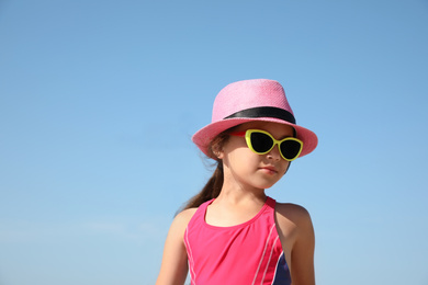 Photo of Cute little child wearing beach hat on sunny day