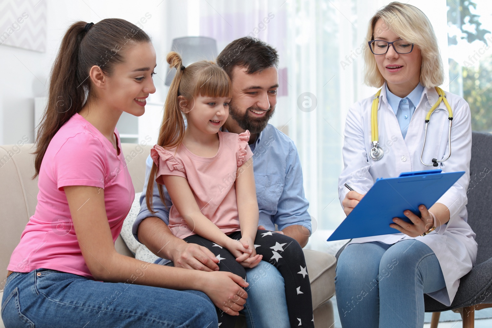 Photo of Children's doctor visiting little girl at home