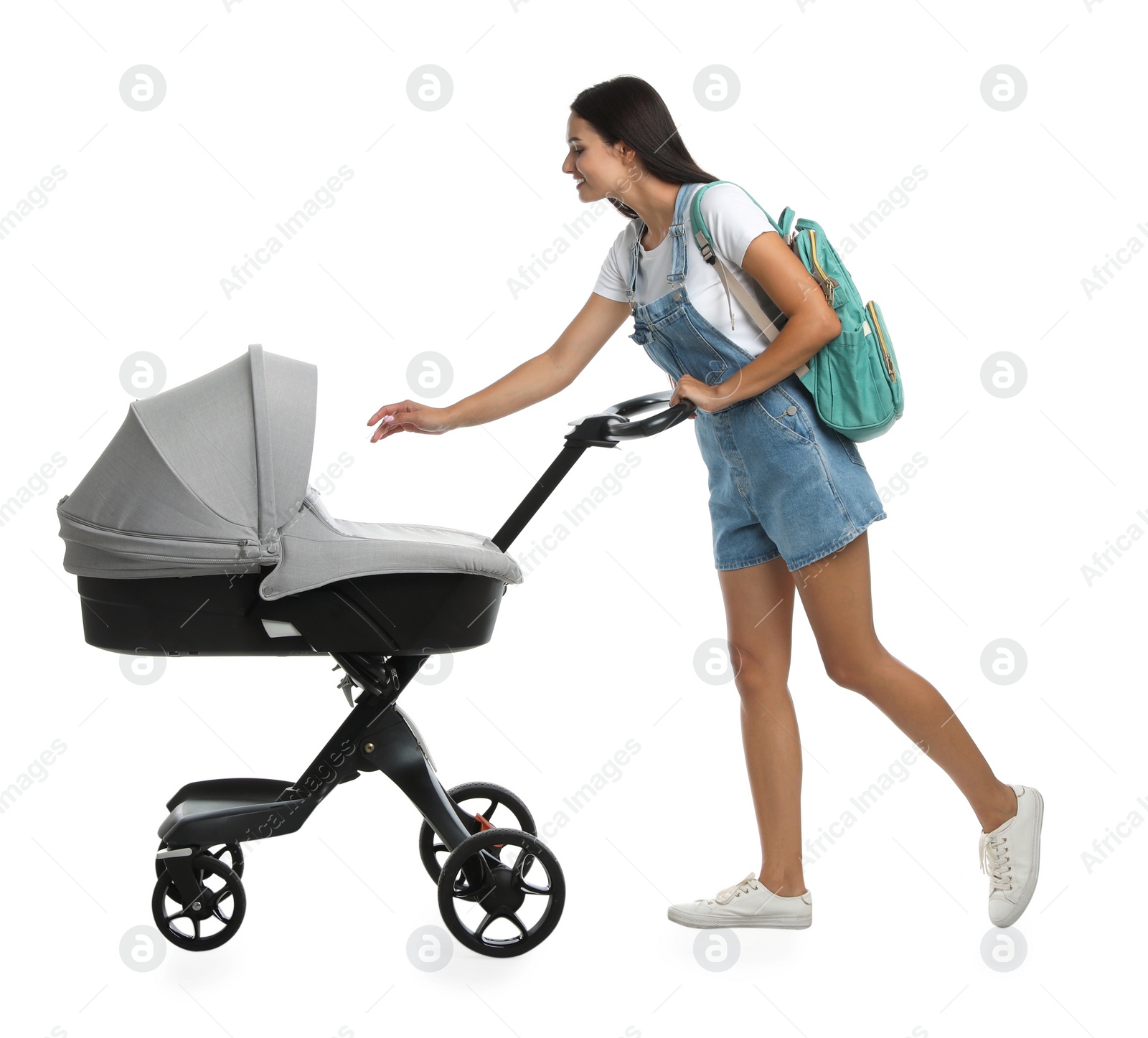 Photo of Happy young woman with baby stroller on white background