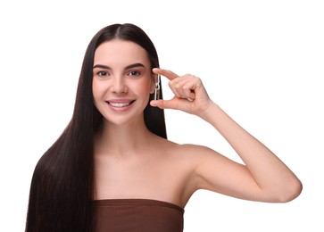 Photo of Beautiful young woman holding skincare ampoule on white background