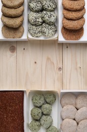 Photo of Many different raw vegan meat products on wooden table, flat lay. Space for text