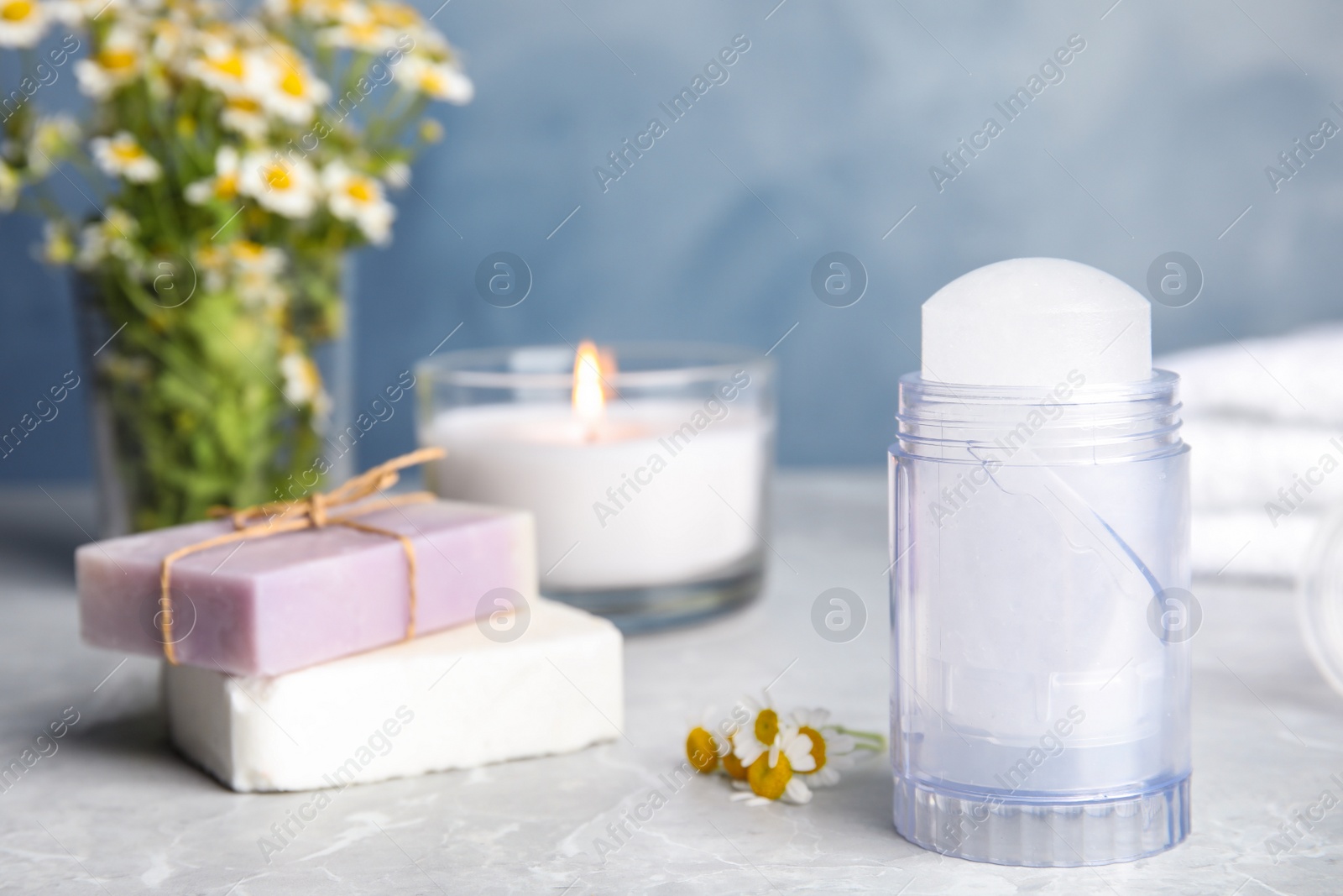 Photo of Natural crystal alum deodorant and handmade soap bars on light grey marble background