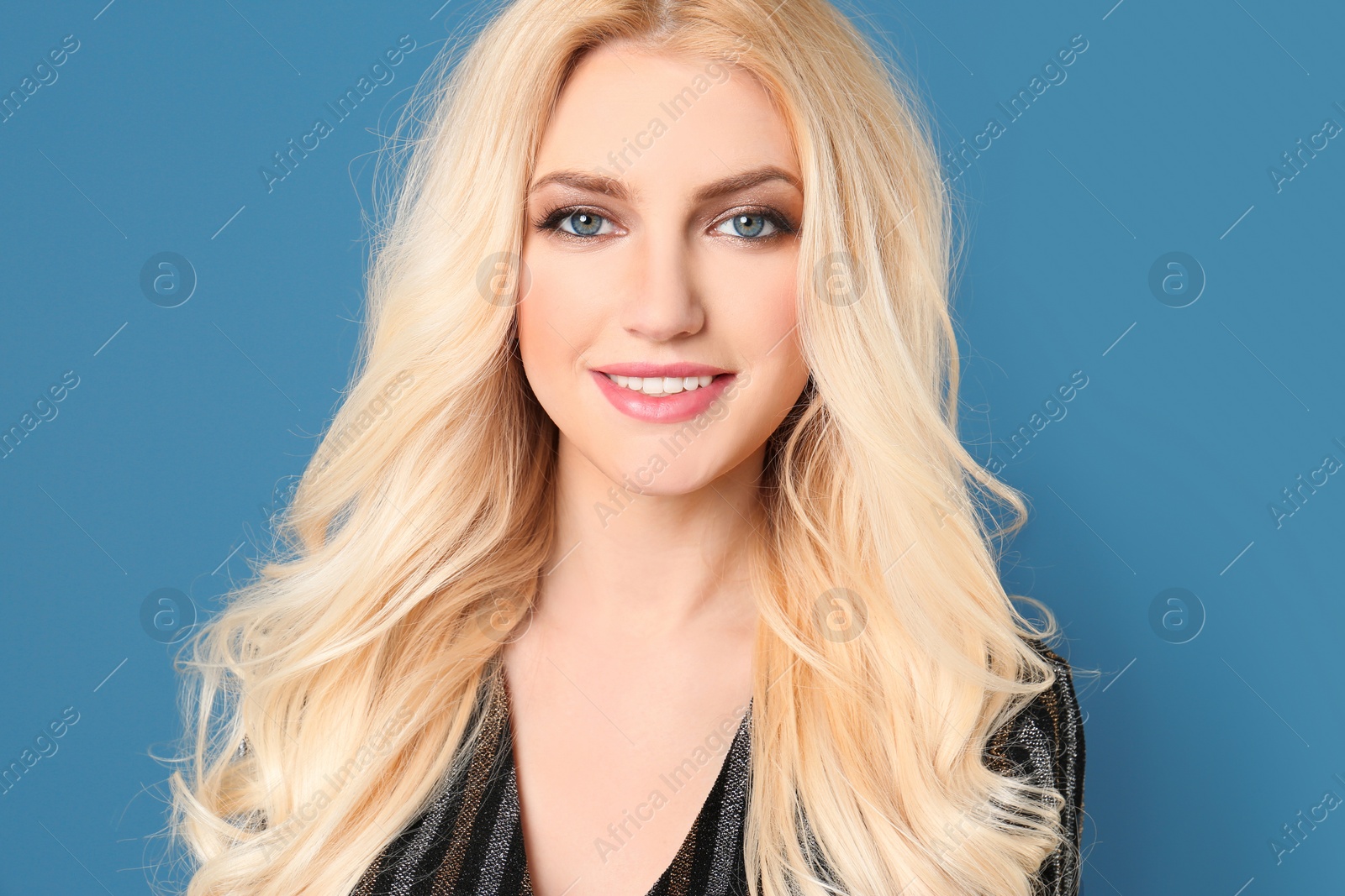 Photo of Portrait of young model with beautiful  hair on color background