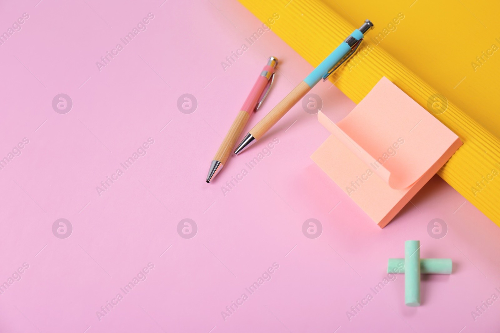 Photo of Composition with pens and sticky notes on color background. Space for text