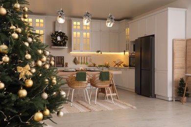 Photo of Cozy open plan kitchen decorated for Christmas. Interior design