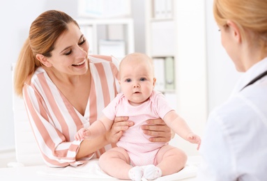 Woman with her baby visiting children's doctor in hospital