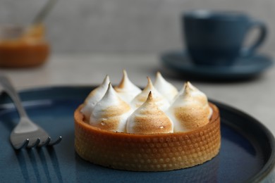 Photo of Tartlet with meringue on table, closeup. Delicious dessert