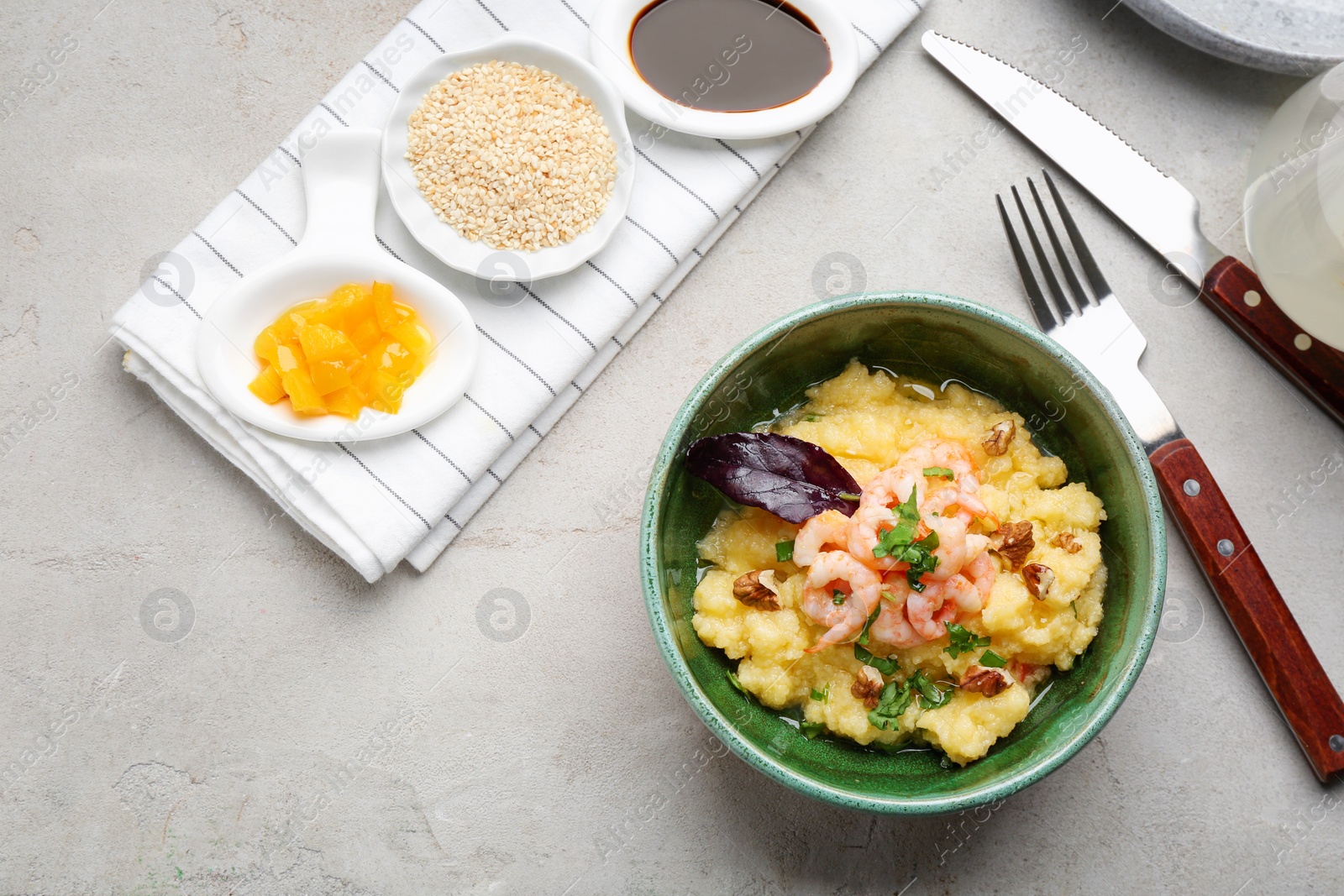 Photo of Flat lay composition with tasty shrimps and grits on grey background