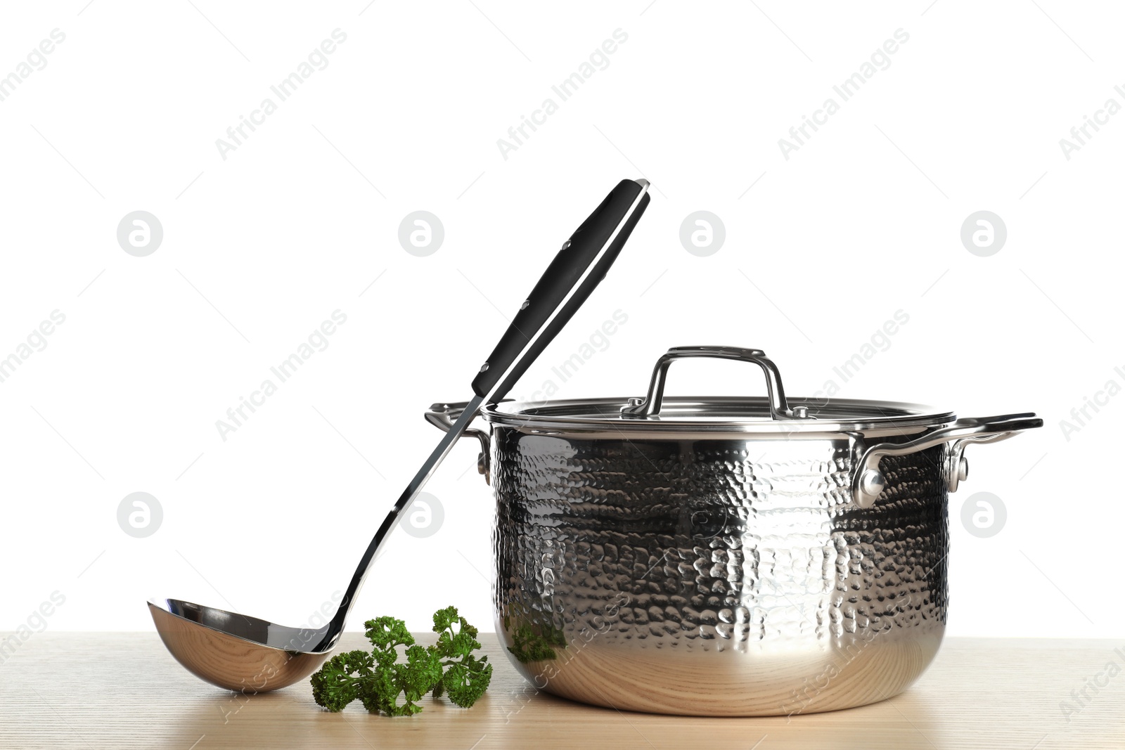 Photo of New clean saucepan and ladle on table against white background