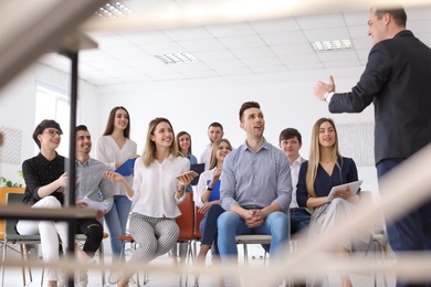 Male business trainer giving lecture in office