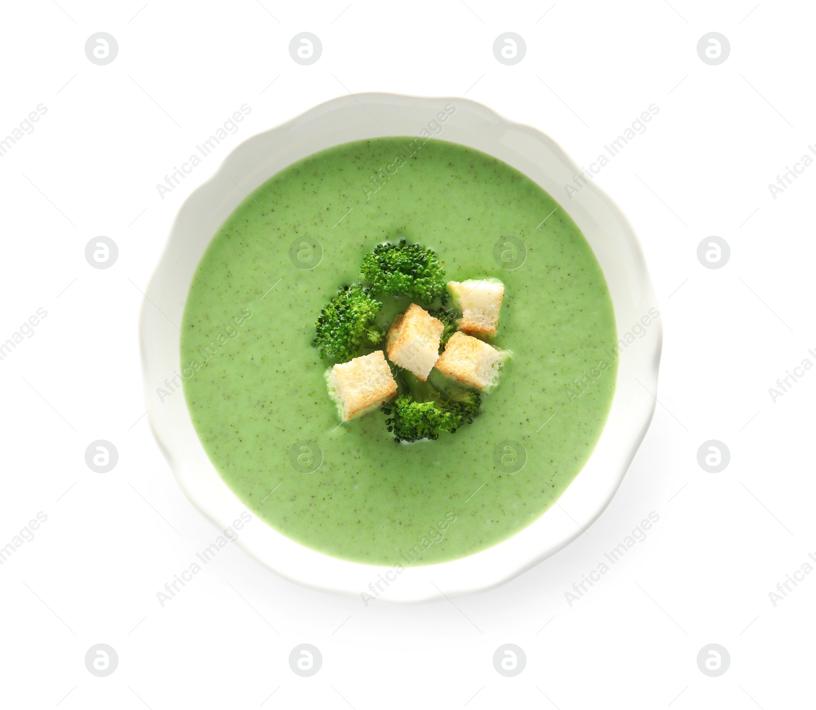 Photo of Fresh vegetable detox soup made of broccoli with croutons in dish on white background, top view