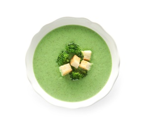 Photo of Fresh vegetable detox soup made of broccoli with croutons in dish on white background, top view