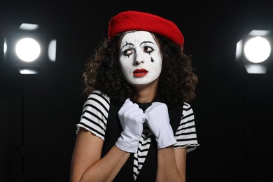 Young woman in mime costume performing on stage
