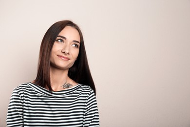 Portrait of pretty young woman with gorgeous chestnut hair on light background, space for text