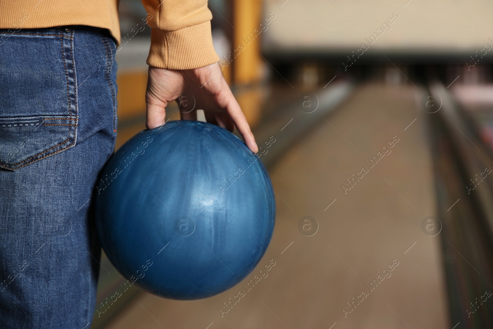 Photo of Man with ball in bowling club, closeup. Space for text