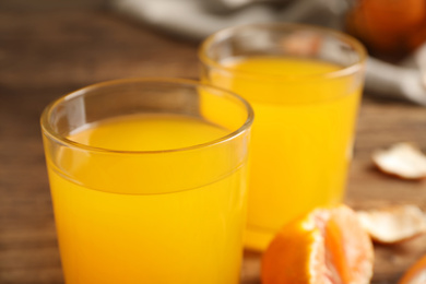 Photo of Glass of fresh tangerine juice, closeup view