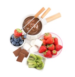 Photo of Fondue pot with melted chocolate, fresh berries, kiwi, marshmallows and forks isolated on white