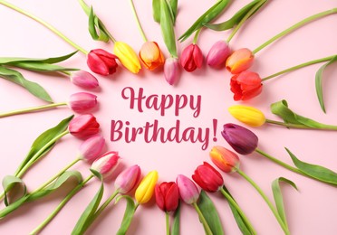Image of Happy Birthday! Heart made with beautiful tulips on pink background, flat lay