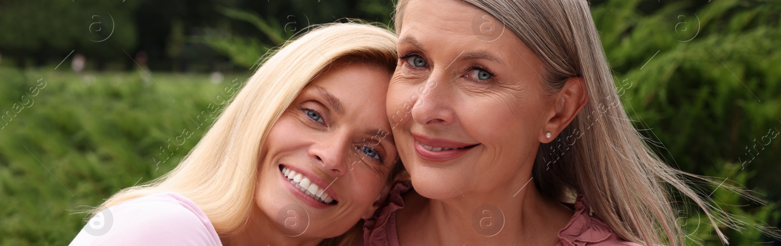 Image of Happy mother and daughter outdoors, banner design