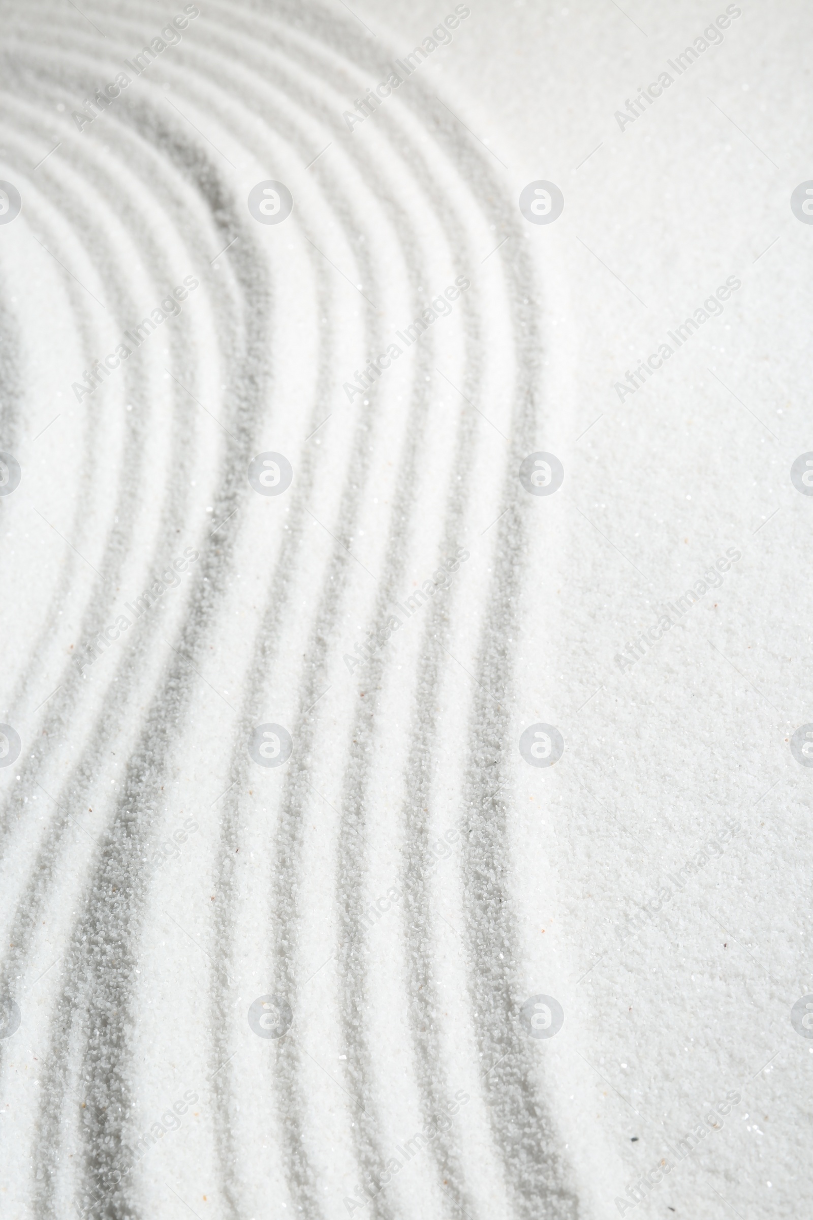 Photo of Zen rock garden. Wave pattern on white sand