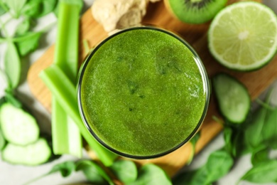 Photo of Delicious fresh green juice in glass, top view