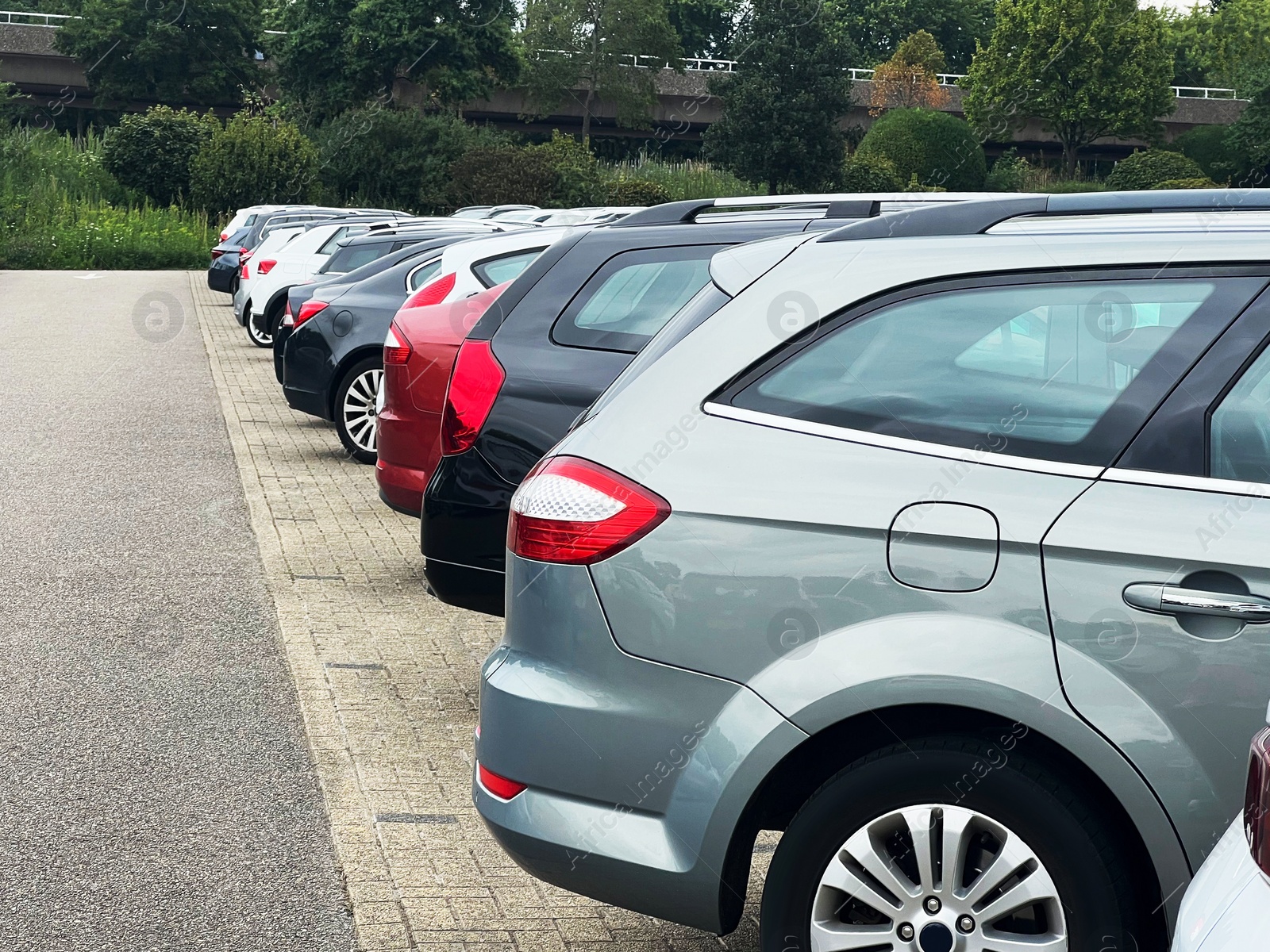 Photo of View of many different cars parked near road