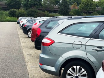 Photo of View of many different cars parked near road