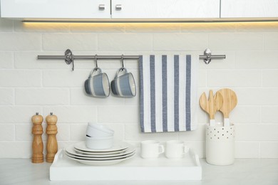 Clean towel, utensils and dishware in kitchen