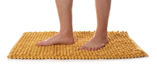 Man standing on soft orange bath mat against white background, closeup