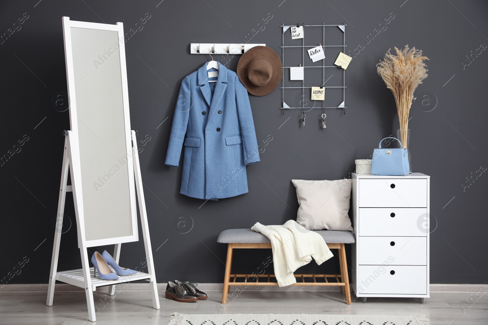 Photo of Hallway interior with stylish furniture, clothes and accessories
